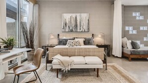 A modern bedroom with a large bed, bedside tables, a desk, and a chair. - Spacious Retreat for Groups W/Workspace Min to DT & SXSW Top Spots! (Austin)