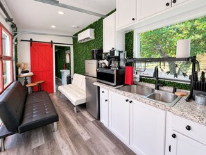 A modern kitchen with a built-in oven, a coffee machine, and a sink. - Best Fredericksburg Bed And Breakfast (Fredericksburg)