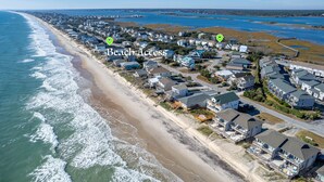 An aerial view of a coastal residential area with houses, a beach, and a pier. - Wonder the Sea:Sweeping Intracoastal Views, Walk to Beach, Hot Tub, Pets Welcome (Surf City)