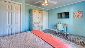 A bedroom with a bed, a desk, a chair, a wardrobe, and a ceiling fan. - Wonder the Sea:Sweeping Intracoastal Views, Walk to Beach, Hot Tub, Pets Welcome (Surf City)