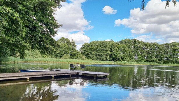 A wooden dock extending into a calm lake surrounded by lush greenery and trees. - Pet friendly apartment in Passow OT Charlottenho (Passow OT Charlottenho)