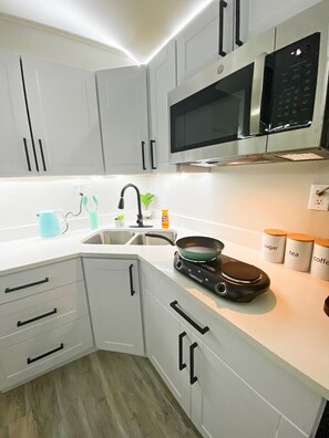 Fridge, microwave, stovetop, coffee/tea maker