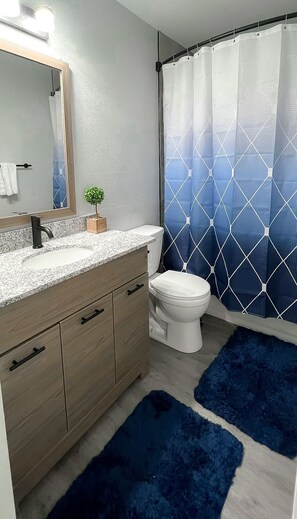 Bathtub, hair dryer, towels, soap