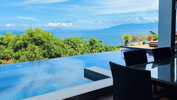 A rooftop infinity pool with a view of the sea and mountains, a covered seating area, and potted plants. - Picturesque private villa with infinity pool (Puerto Galera)
