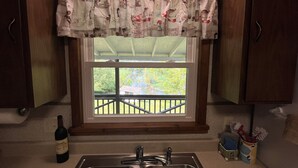 A kitchen with a window, a wine bottle, and a sink. - Winding River - Panoramic view of river valley, under 10 minutes to Dreams Park (Cooperstown)