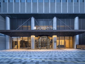 A modern building with a prominent entrance featuring a glass facade and a sign reading "Pullman". - Pullman Shenzhen North (Shenzhen)