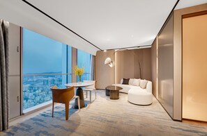 A modern hotel room with a city view, a round table, a sofa, and a floor lamp. - Pullman Shenzhen North (Shenzhen)