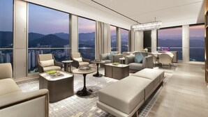 A modern hotel room with a panoramic city view, large windows, and contemporary furnishings. - Pullman Shenzhen North (Shenzhen)