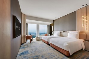 A hotel room with a large bed, a desk, and a view of the city. - Pullman Shenzhen North (Shenzhen)