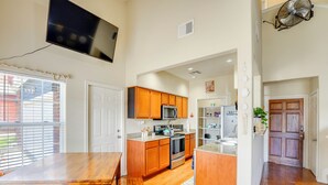 A spacious kitchen with wooden cabinets, a microwave, and a large island. - Afton Townhome w/ Pool Access < Half-Mi to Boating (Afton)