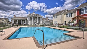 A swimming pool with a metal ladder and steps, surrounded by a fence. - Walk to Lake: Townhome w/ Hot Tub in Afton! (Afton)