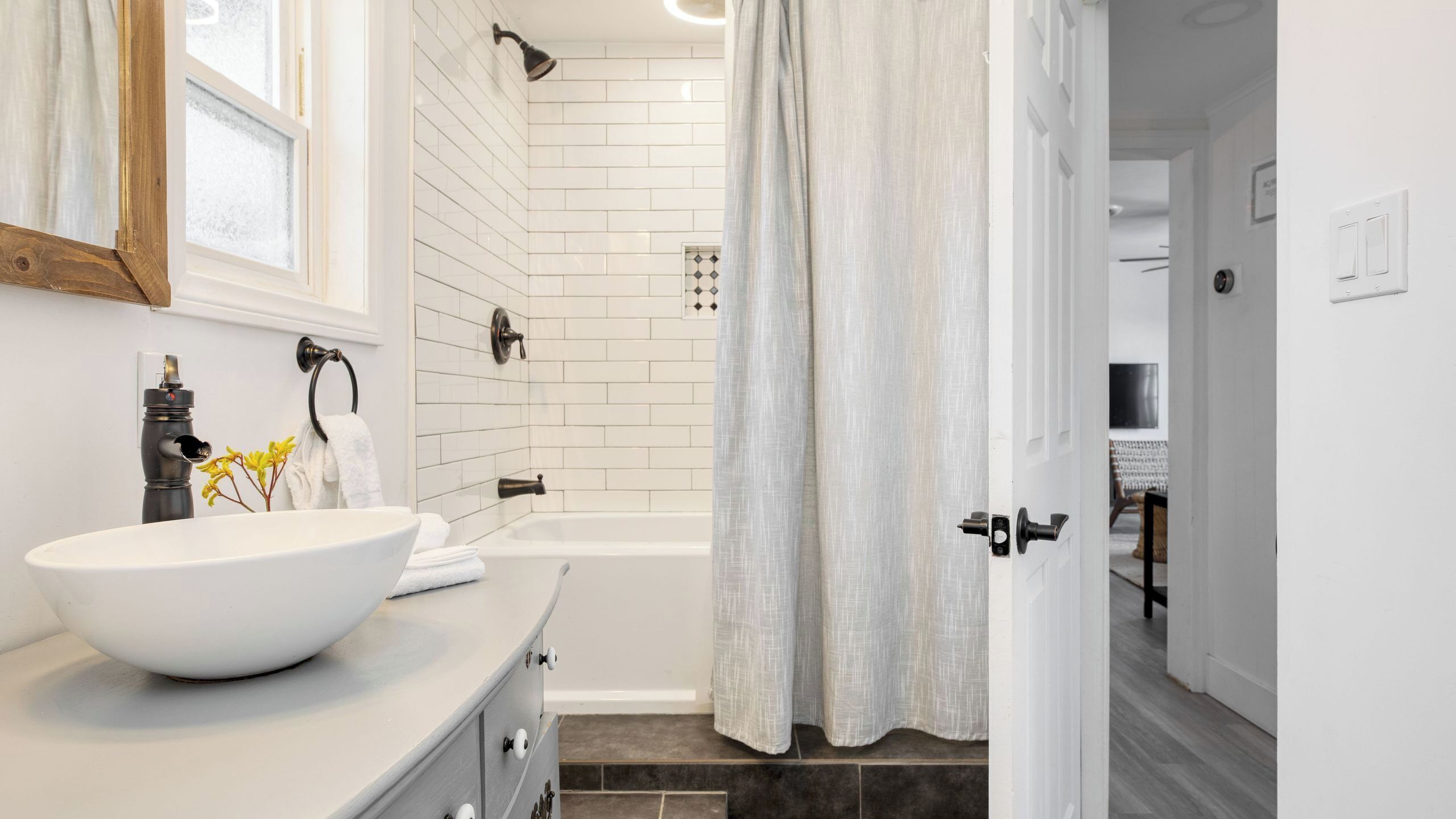 A bathroom with a white sink, a bathtub, and a shower.