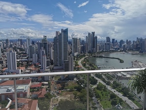 Panoramic cityscape with a meandering river and high-rise buildings.