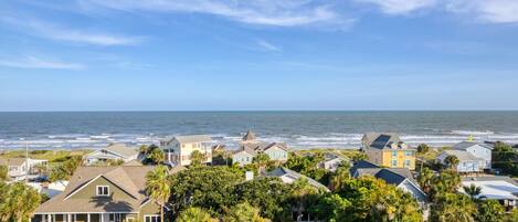 A coastal residential area with houses and a view of the ocean.