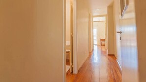 A hallway with wooden flooring and white walls. - Cozy Two Bedroom Apt in Central Alfama | With A/c by Lisbeyond (Lisboa)