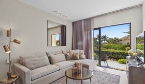 A modern living room with a sofa, a coffee table, and a floor lamp.