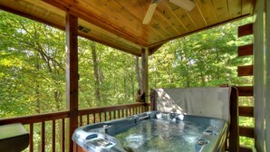 A hot tub on a wooden deck with a view of a forest. - Cozy Retreat with Hot Tub, Firepit & Fireplace! - Bearfoot Ridge (Blue Ridge)
