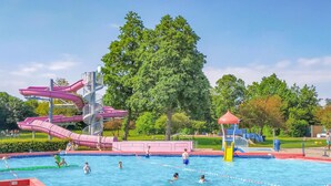 A swimming pool with multiple slides and a playground area. - Awesome home in Heinkenszand with WiFi (Heinkenszand)