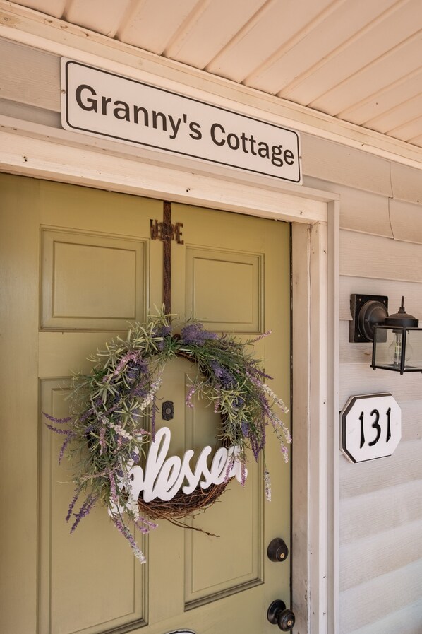 A door with a sign reading 'Granny's Cottage' above it.
