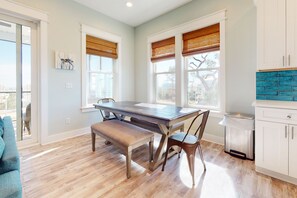 Enjoy meals in the kitchen and dining area with a wooden table and bench seating.