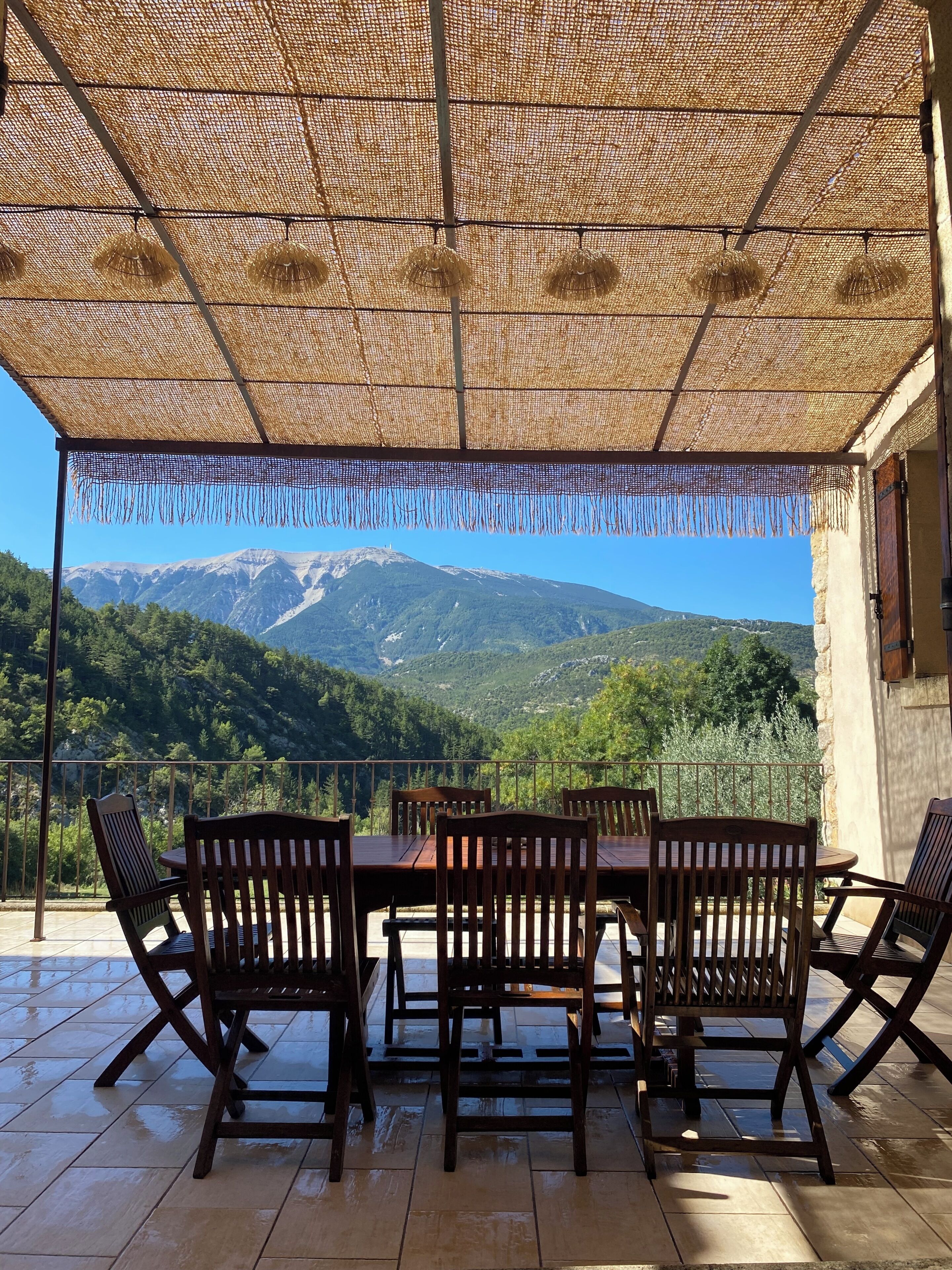 An outdoor dining area with a view of a mountain range.