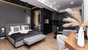 A modern bedroom with a bed, bedside table, and a desk with a chair. - Stay Inn  on Buzand Str. 97 (Yerevan)