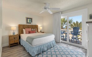 A bedroom with a bed, nightstands, a ceiling fan, a window with curtains, and a view of the outdoors. - Inlet Beach + Gulf View, Pet Friendly & Bikes (Inlet Beach)