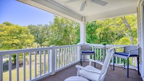 Enjoy dining or socializing in this serene outdoor space surrounded by trees.