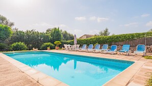 A rectangular swimming pool with clear blue water, surrounded by a tiled deck. - Finca "Can Miquel des Revellar" with Mountain View, Pool & Wi-Fi (Campos)