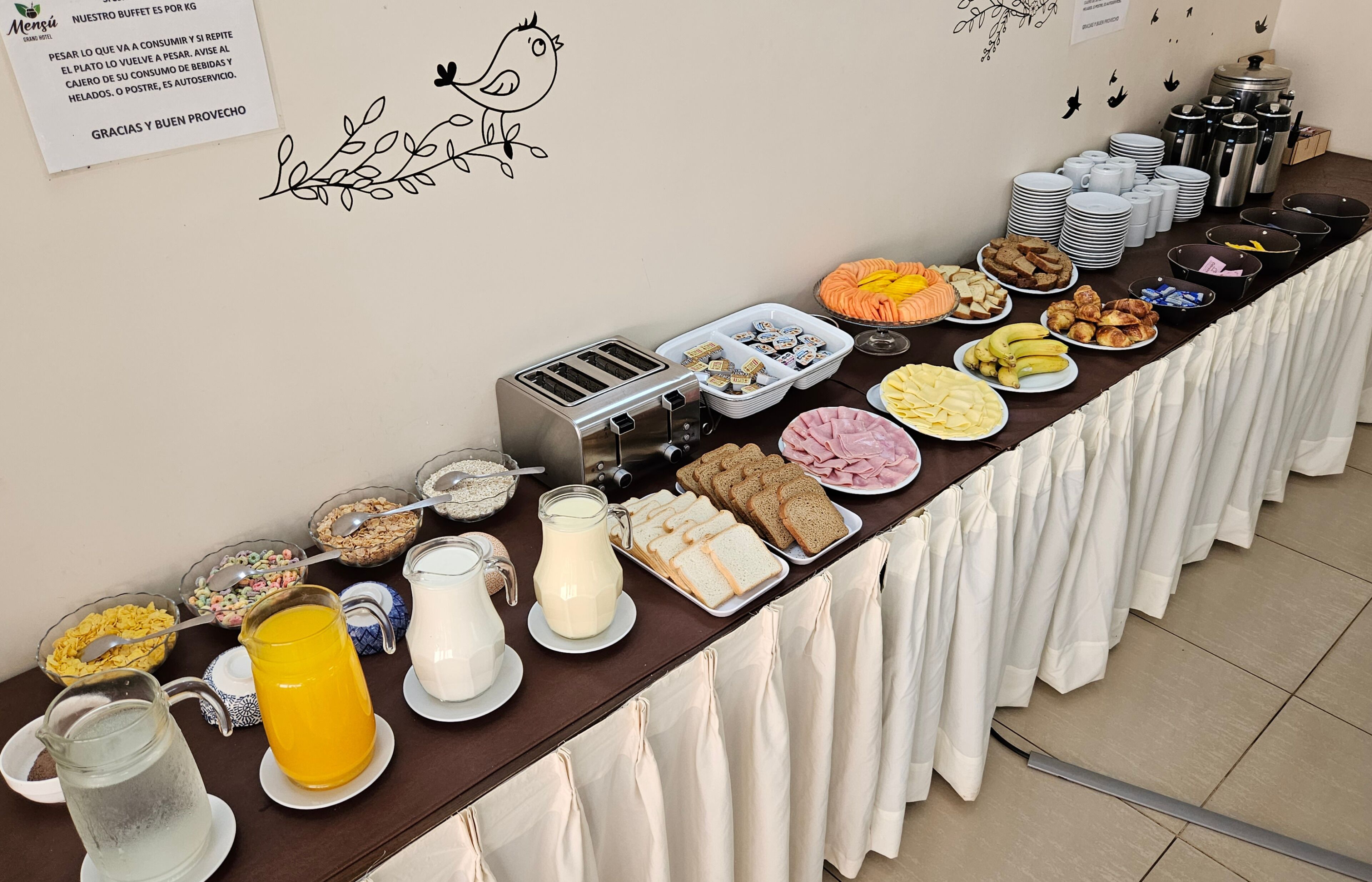A buffet table with various food items and a toaster.