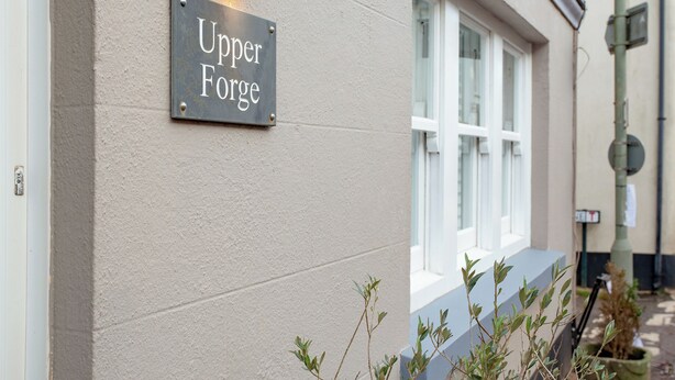 A sign reading "Upper Forge" mounted on a building wall. - 2 bedroom accommodation in Malborough (Malborough)