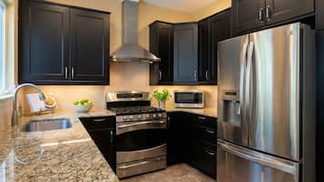 Coffee/tea maker, fridge, cookware/dishes/utensils