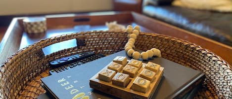 A woven basket on a table with a book titled "Mulle Deer" and a wooden abacus.