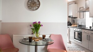 A modern kitchen with a dining area.