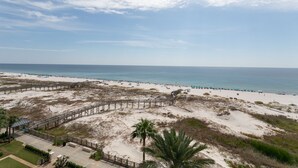 A beach with a wooden boardwalk, sandy dunes, and a clear view of the ocean. - Relaxing Gulf Views at the Beach Club in Fort Morgan! (Gulf Shores)