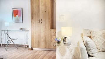 A modern room with a wooden wardrobe, a glass desk with a lamp, and a bed with a textured blanket.
