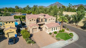 A large, multi-story house with a spacious backyard, multiple garages, and a swimming pool. - Heated pool, jacuzzi, Fast Wifi, Pac Man, Fire Pit, BBQ, Sleeps 14! (Phoenix)