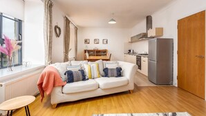 A modern apartment with a living room, kitchen, and dining area. - No27 The Barclay - Donnini Apartments (Kilmarnock)