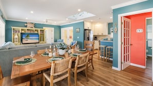 A modern kitchen with white cabinets, a built-in oven, and a refrigerator.