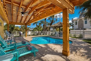 A heated pool, sun loungers