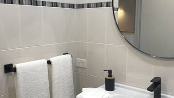 Shower, hair dryer, towels, toilet paper