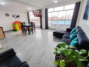 Deluxe Apartment, 3 Bedrooms, Kitchen | Living area | 55-inch Smart TV with digital channels, Netflix, toys
