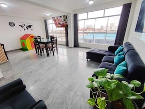Deluxe Apartment, 3 Bedrooms, Kitchen | Living area | 55-inch Smart TV with digital channels, Netflix, toys