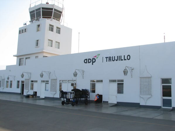 A white building with the text "adp | TRUJILLO" on the side.