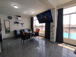 Family Apartment, 2 Bedrooms, Kitchen | Living area | 55-inch Smart TV with digital channels, Netflix, toys