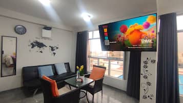 Family Apartment, 2 Bedrooms, Kitchen | Living area | 55-inch Smart TV with digital channels, Netflix, toys