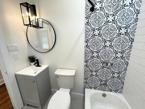 Combined shower/bathtub, hair dryer, towels, soap - Naturally Beautiful 3 Bedroom Home -  Restored with Modern and Historic Touches (New Orleans)