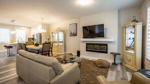 Una sala de estar moderna con sofá, mesa de centro y chimenea.