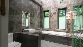 A modern bathroom with a bathtub, a sink, and a toilet.