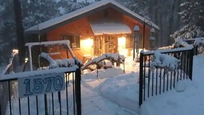 A wooden cabin with a snow-covered entrance and a number '1570' on the gate. - Wheelchair Access, Near Ski & Snow Play, Pets OK! (Wrightwood)